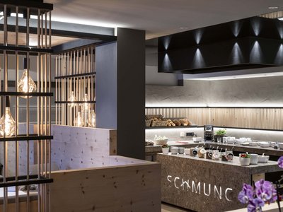 Hotel Schmung: holidays in harmony with nature Modern breakfast buffet with wooden accents and warm lighting