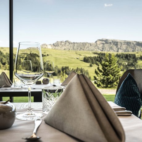 Hotel Schmung: our picture gallery Table set with view of green mountains through restaurant window