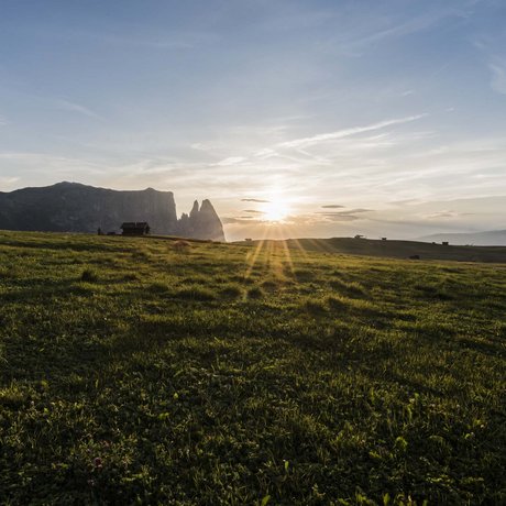 Hotel Schmung: our picture gallery Sunset over a green mountain meadow with rocks and huts in the background