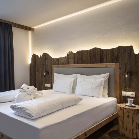 Hotel Schmung: our picture gallery Modern bedroom with double bed, bunk bed, and wooden design elements