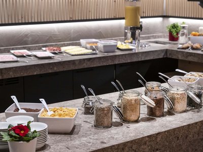 Culinary highlights at Hotel Schmung Buffet with cereals, muesli, and cold cuts for breakfast