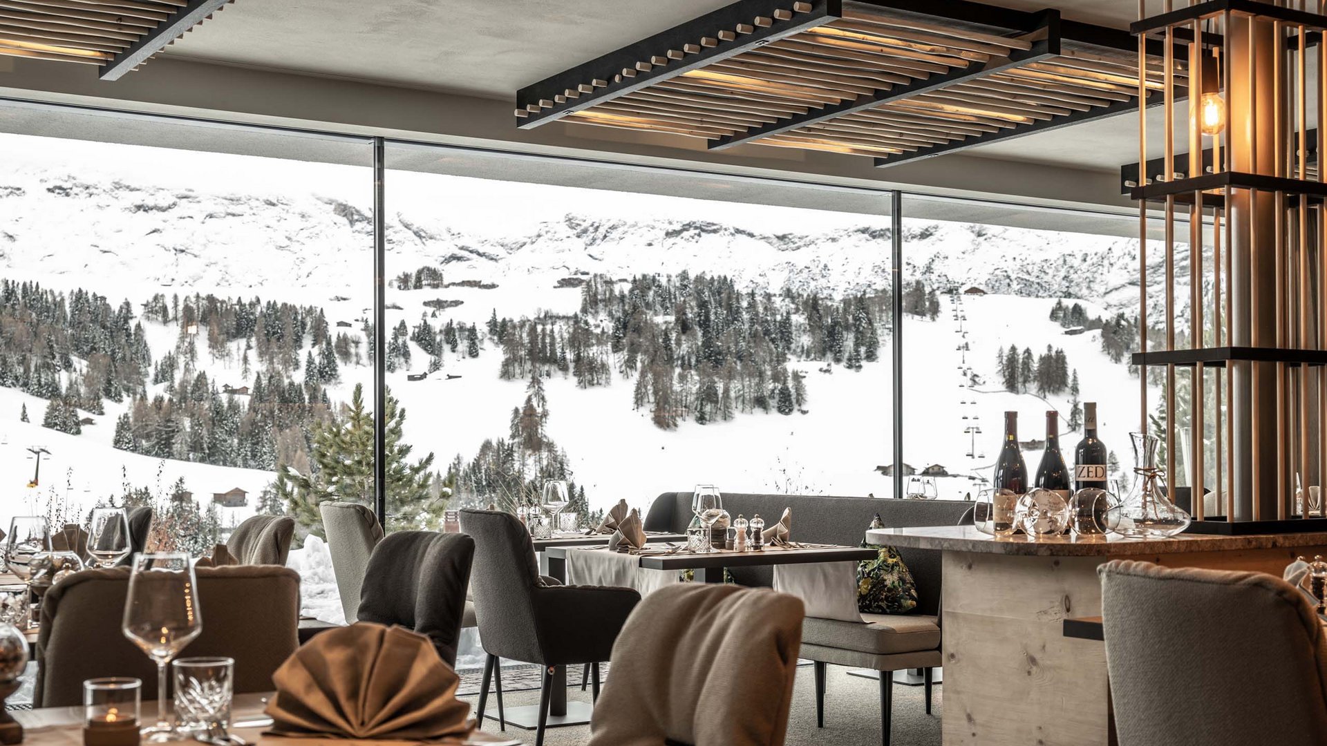 Hotel Schmung: holidays in harmony with nature Cozy restaurant with view of snowy mountains and pine trees