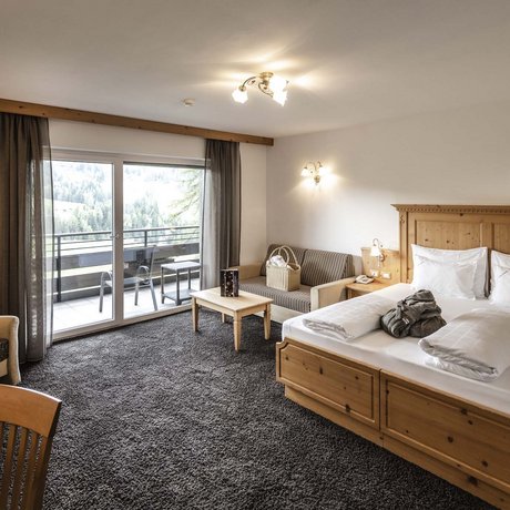 Hotel Schmung: our picture gallery Cozy hotel room with wooden furniture and balcony with mountain view