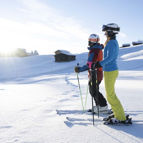 Hotel Schmung: our picture gallery Two skiers standing on snowy slope at sunrise