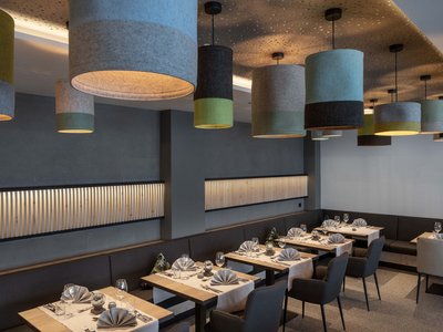 Culinary highlights at Hotel Schmung Modern restaurant interior with decorative lights and set tables