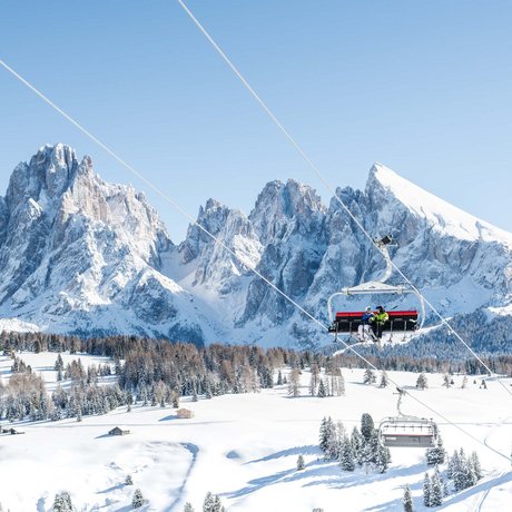 Hotel Schmung: our picture gallery Ski lift with passengers in front of snowy mountains and clear sky