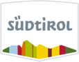 Logo Südtirol mit Berggrafik in Grün, Rot und Gelb