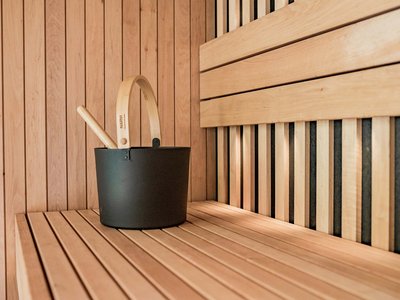 Hotel Schmung: wellness at Alpe di Siusi/Seiser Alm Black sauna bucket with wooden handle in light wood sauna