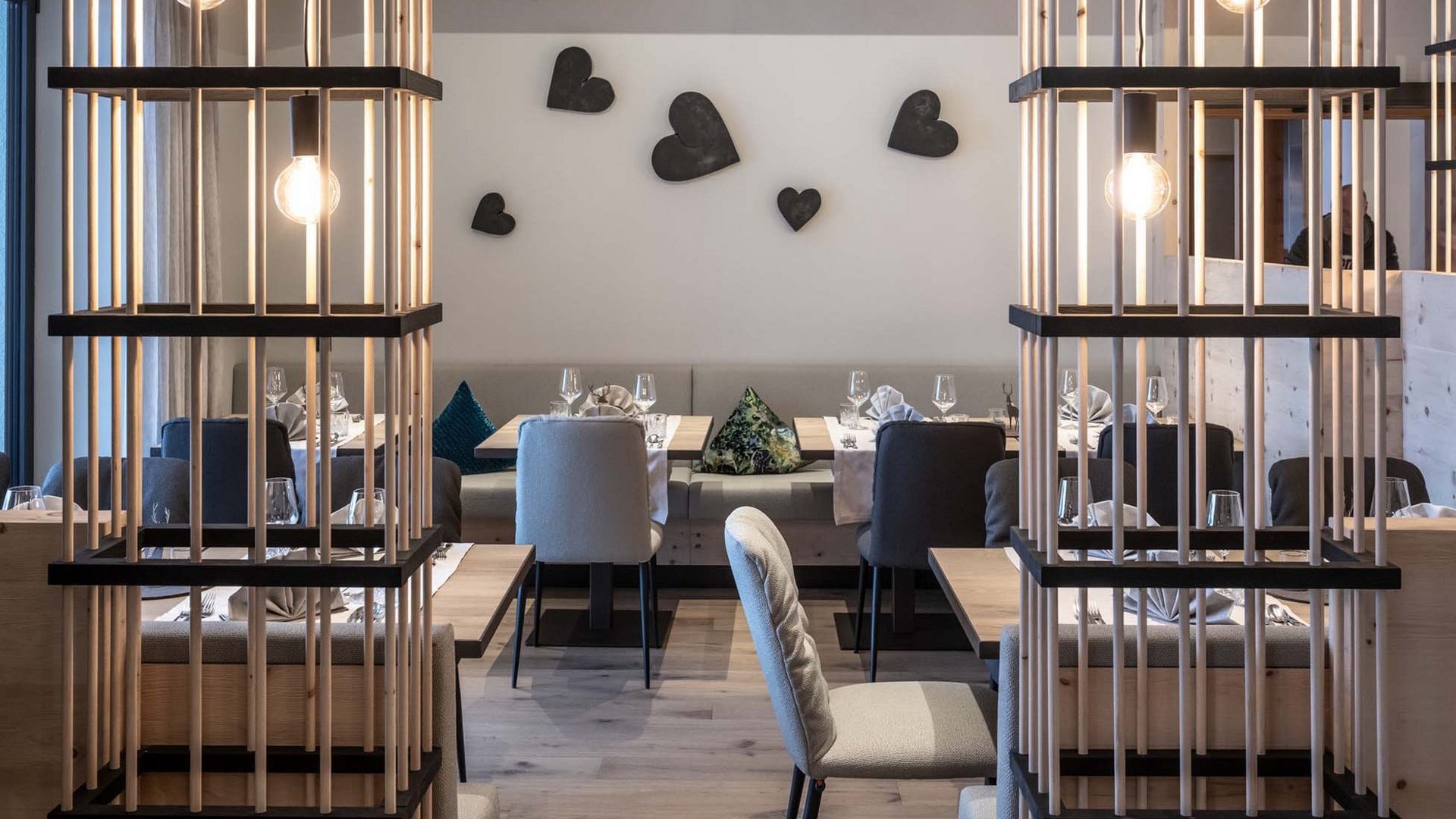 Culinary highlights at Hotel Schmung Modern restaurant interior with wooden partitions and heart-shaped wall decorations
