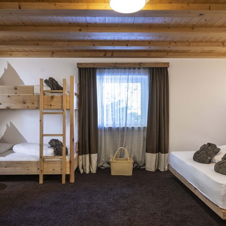Hotel Schmung: our picture gallery Room with bunk bed, double bed, and natural wood furniture