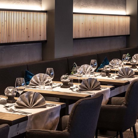 Hotel Schmung: our picture gallery Elegant restaurant with set tables, wine glasses, and soft lighting